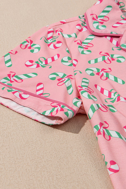 Roze kerstpyjamaset met knoop en zakmotief in zuurstokprint