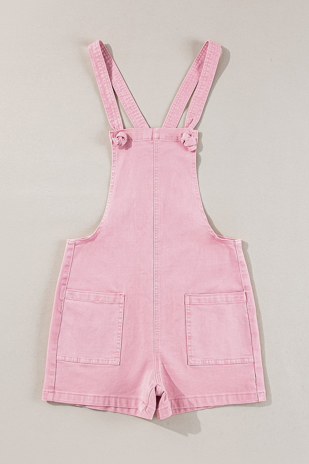 Roze effen denim romper met knoopbandjes en zakken