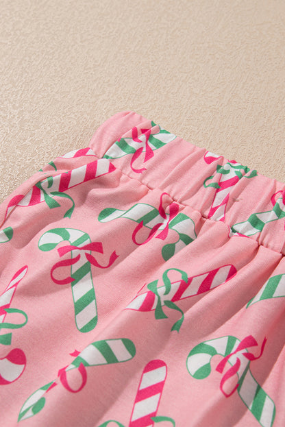 Roze kerstpyjamaset met knoop en zakmotief in zuurstokprint