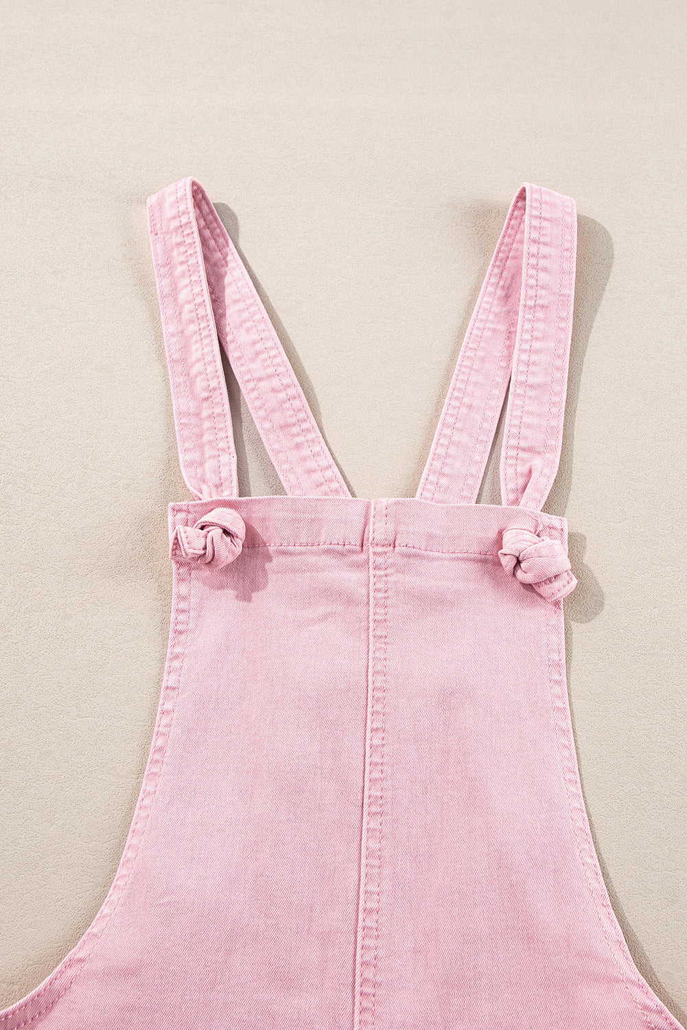 Roze effen denim romper met knoopbandjes en zakken